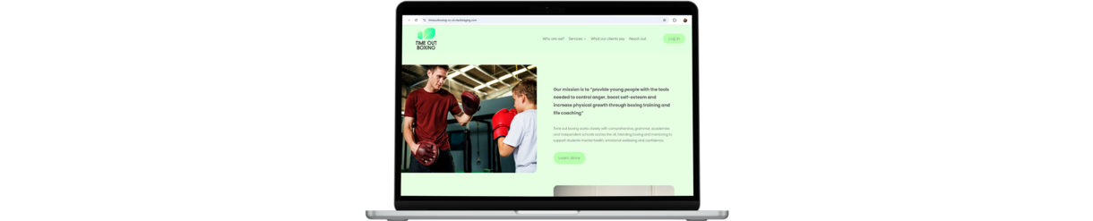 Laptop with image of old website showing a kid and adult sparring